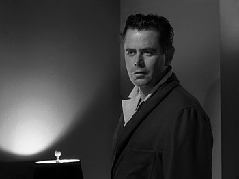 Movie still from “The Big Heat” (1953), directed by Fritz Lang – A black and white photo of a man in a robe; Close Up shot, Low angle