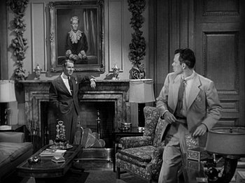 Movie still from “The Big Heat” (1953), directed by Fritz Lang – Two men in suits and ties in a living room with a fireplace; Wide shot, Over the shoulder angle