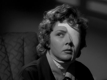 Movie still from “The Big Heat” (1953), directed by Fritz Lang – A black and white photo of a woman with a bandage on her face; Close Up shot, Low angle