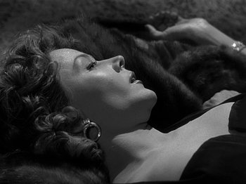 Movie still from “The Big Heat” (1953), directed by Fritz Lang – A black and white photo of a woman laying on the ground; Close Up shot, Overhead angle