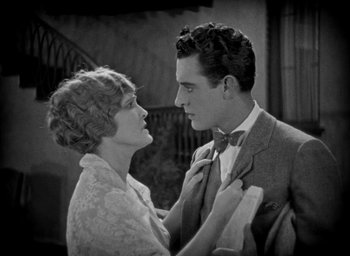 Movie still from “The Big Parade” (1925), directed by King Vidor – A man and a woman standing next to each other; Medium shot, High angle