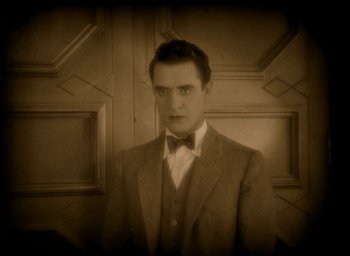 Movie still from “The Big Parade” (1925), directed by King Vidor – A man in a suit and bow tie; Close Up shot, High angle