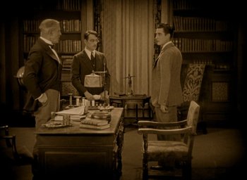 Movie still from “The Big Parade” (1925), directed by King Vidor – A group of men standing around a table in a room; Wide shot, High angle