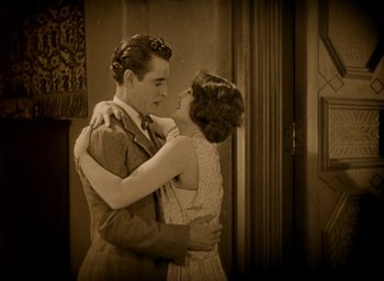 Movie still from “The Big Parade” (1925), directed by King Vidor – A man and a woman embracing in a room; Medium shot, High angle