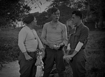 Movie still from “The Big Parade” (1925), directed by King Vidor – A group of men standing next to each other on a field; Medium shot, High angle