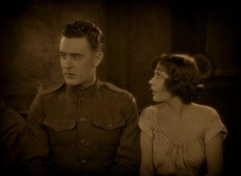 Movie still from “The Big Parade” (1925), directed by King Vidor – A man and a woman are standing next to each other; Medium shot, High angle