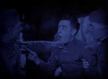 Movie still from “The Big Parade” (1925), directed by King Vidor – A group of men in uniforms are fighting; Medium shot, High angle