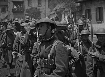 Movie still from “The Big Parade” (1925), directed by King Vidor – A black and white photo of a group of men in uniform; Medium shot, Low angle