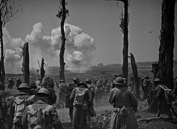 Movie still from “The Big Parade” (1925), directed by King Vidor – A group of men standing next to each other on top of a field; Extreme Wide shot, Low angle