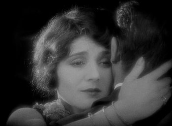 Movie still from “The Big Parade” (1925), directed by King Vidor – An old photo of a woman and a man hugging; Close Up shot, High angle