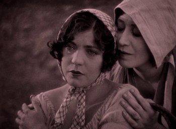 Movie still from “The Big Parade” (1925), directed by King Vidor – A woman in a checkered hat and a woman in a hooded jacket; Close Up shot, High angle