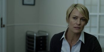 Movie still from “House of Cards” (2013), created by Beau Willimon – A person sitting in a room; Close Up shot, Over the shoulder angle