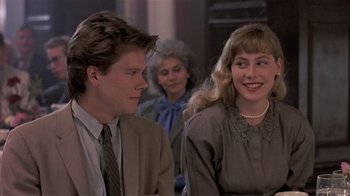 Movie still from “The Big Picture” (1989), directed by Christopher Guest – A man and a woman sitting next to each other in front of another woman; Close Up shot, Over the shoulder angle