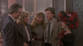 Movie still from “The Big Picture” (1989), directed by Christopher Guest – A group of people standing next to each other in a room; Medium shot, Over the shoulder angle