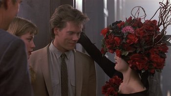 Movie still from “The Big Picture” (1989), directed by Christopher Guest – A man and a woman wearing a floral headpiece; Close Up shot, Over the shoulder angle