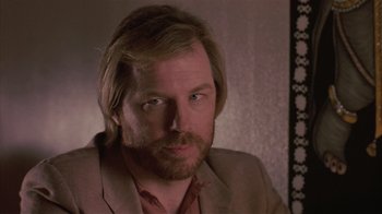 Movie still from “The Big Picture” (1989), directed by Christopher Guest – A person wearing a suit and tie; Close Up shot, Low angle