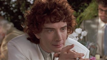 Movie still from “The Big Picture” (1989), directed by Christopher Guest – A person with curly hair; Close Up shot, Over the shoulder angle