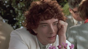 Movie still from “The Big Picture” (1989), directed by Christopher Guest – A person with curly hair; Close Up shot, Over the shoulder angle