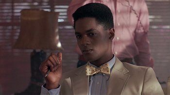 Movie still from “The Big Picture” (1989), directed by Christopher Guest – A man in a suit and a bow tie holding a cigarette; Close Up shot, Over the shoulder angle