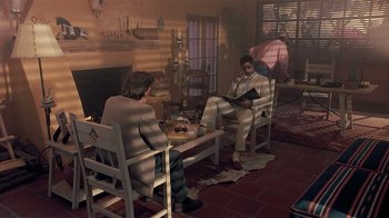 Movie still from “The Big Picture” (1989), directed by Christopher Guest – Two men sitting at a coffee table in a living room; Wide shot, High angle