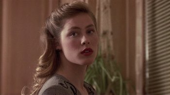 Movie still from “The Big Picture” (1989), directed by Christopher Guest – A young woman with long blonde hair wearing a gray top; Close Up shot, Over the shoulder angle