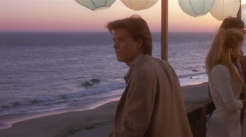 Movie still from “The Big Picture” (1989), directed by Christopher Guest – A man standing on a beach next to the ocean; Medium shot, Over the shoulder angle