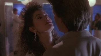 Movie still from “The Big Picture” (1989), directed by Christopher Guest – A young woman with long hair is looking at a young man with long hair; Close Up shot, Over the shoulder angle