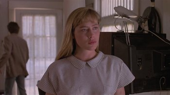 Movie still from “The Big Picture” (1989), directed by Christopher Guest – A woman with long blonde hair wearing a checkered shirt; Close Up shot, Low angle