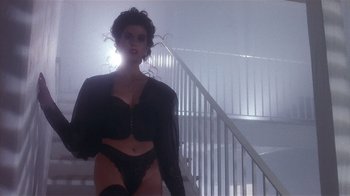 Movie still from “The Big Picture” (1989), directed by Christopher Guest – A woman in lingerie standing in front of a staircase; Medium shot, Low angle