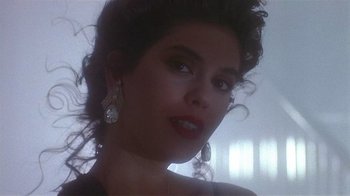 Movie still from “The Big Picture” (1989), directed by Christopher Guest – A person wearing a necklace and earrings; Close Up shot, Low angle