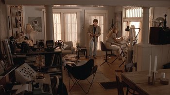 Movie still from “The Big Picture” (1989), directed by Christopher Guest – A man and a woman are sitting in a living room; Wide shot, High angle
