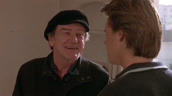 Movie still from “The Big Picture” (1989), directed by Christopher Guest – A man wearing a hat talking to another man; Close Up shot, Over the shoulder angle