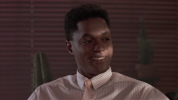 Movie still from “The Big Picture” (1989), directed by Christopher Guest – A young man wearing a striped shirt and a pink tie; Close Up shot, Low angle