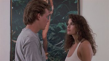 Movie still from “The Big Picture” (1989), directed by Christopher Guest – A man and a woman standing next to each other in front of a painting; Medium shot, Over the shoulder angle