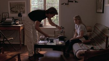 Movie still from “The Big Picture” (1989), directed by Christopher Guest – A woman and a girl sitting in a living room next to each other; Medium shot, High angle
