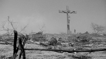 Movie still from “The Big Red One” (1980), directed by Samuel Fuller – An old photo of a cross in the middle of a field; Wide shot, Low angle