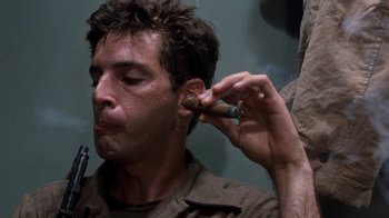 Movie still from “The Big Red One” (1980), directed by Samuel Fuller – A man is smoking a cigarette in a room; Close Up shot, Low angle