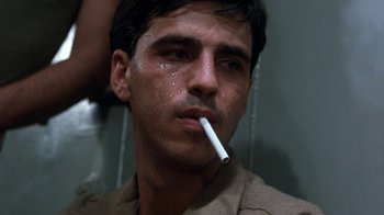 Movie still from “The Big Red One” (1980), directed by Samuel Fuller – A person with a cigarette in his mouth; Close Up shot, Low angle
