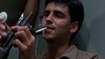 Movie still from “The Big Red One” (1980), directed by Samuel Fuller – A man smoking a cigarette while holding an electronic device; Close Up shot, Low angle