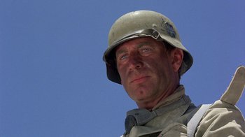 Movie still from “The Big Red One” (1980), directed by Samuel Fuller – A man wearing a helmet is looking at the camera; Close Up shot, Low angle