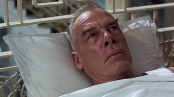 Movie still from “The Big Red One” (1980), directed by Samuel Fuller – An older man laying in a hospital bed; Close Up shot, Low angle
