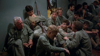 Movie still from “The Big Red One” (1980), directed by Samuel Fuller – A group of men sitting on the ground; Medium shot, High angle