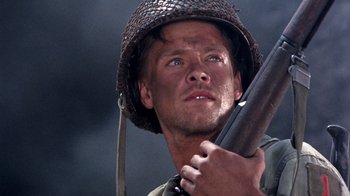 Movie still from “The Big Red One” (1980), directed by Samuel Fuller – A man holding a gun wearing a hat; Close Up shot, Low angle