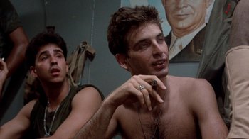 Movie still from “The Big Red One” (1980), directed by Samuel Fuller – A man smoking a cigarette next to another man; Close Up shot, Low angle