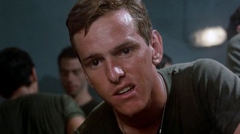 Movie still from “The Big Red One” (1980), directed by Samuel Fuller – A person with a face close to the camera; Close Up shot, Low angle