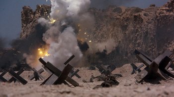 Movie still from “The Big Red One” (1980), directed by Samuel Fuller – An image of an explosion in the middle of the desert; Extreme Wide shot, High angle