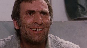 Movie still from “The Big Red One” (1980), directed by Samuel Fuller – A person smiling; Close Up shot, Low angle