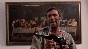 Movie still from “The Big Red One” (1980), directed by Samuel Fuller – A man holding a gun and smoking a cigarette in front of a painting; Medium shot, Low angle