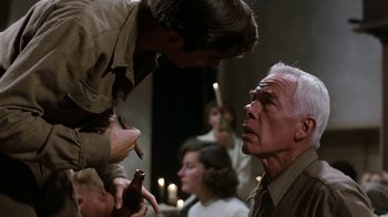 Movie still from “The Big Red One” (1980), directed by Samuel Fuller – An older man smoking a cigarette while a younger man looks at him; Close Up shot, Over the shoulder angle