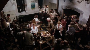 Movie still from “The Big Red One” (1980), directed by Samuel Fuller – A group of people sitting around a table with food on top of it; Wide shot, Overhead angle